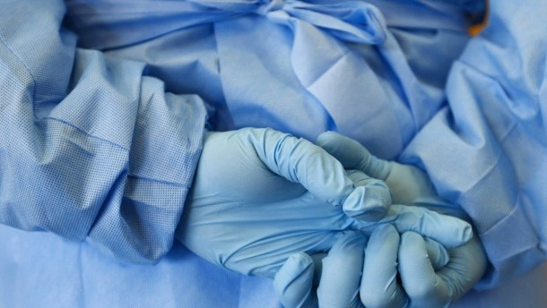 file-picture-shows-the-gloved-hands-of-an-army-nurse-during-a-demonstration-of-an-isolation-chamber-for-the-treatment-of-infectious-disease-patients-in-koblenz